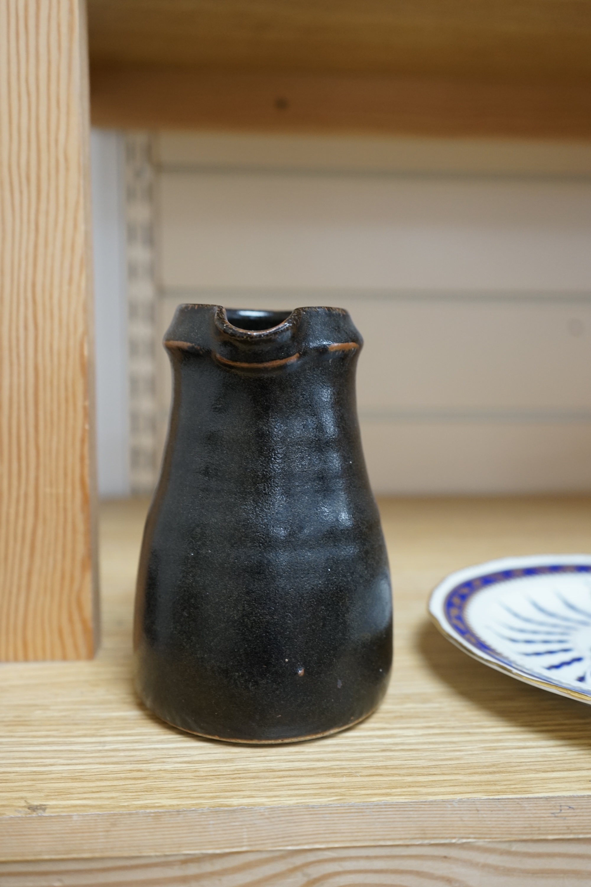 Leach standard ware, a small Stoneware black glazed studio pottery jug, impressed mark to top of foot rim, 15.5cm high. Condition - good